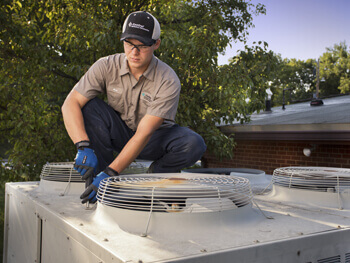 HVAC technician conducting a maintenance check on an HVAC system